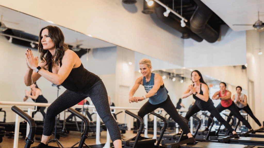 An image of a Pilates class. We know a first class can be intimidating. Here's how to overcome that fear.